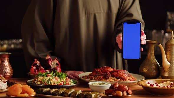 Kabsa Hummus Dolma Maqluba Tabbouleh Closeup Smartphone with Blue Chroma Key Screen Middle Eastern alt