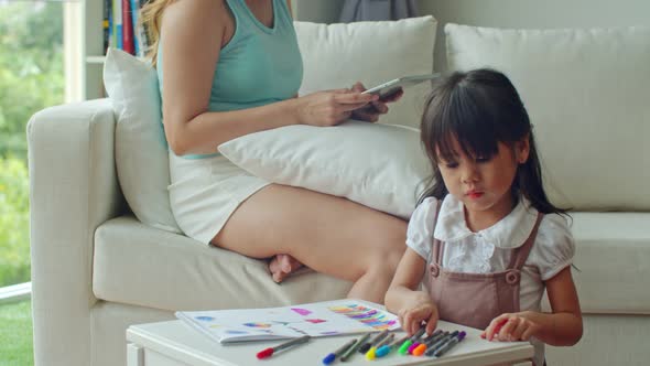 Daughter shows picture drawn to mother proud in little girl