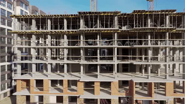 Aerial view of high residential apartment building under construction. Real estate development. alt