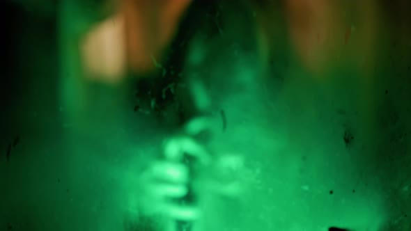 Scary ghost woman screaming through dirty glass on dark background. alt