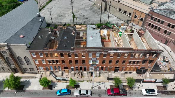 Abandoned boarded up homes in crime neighborhood in USA. Missing roof and windows. Aerial view in US alt