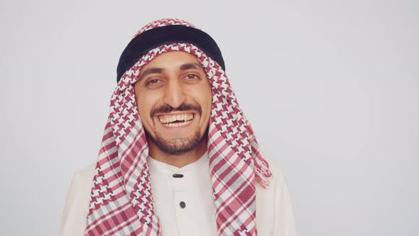 A Man with a Beard and National Clothes Smiles and Enjoys the Deal. An Arab in a Modern Office alt