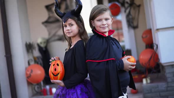 Live Camera Spinning Zoom in to Smiling Confident Children in Halloween Costumes Posing Outdoors alt