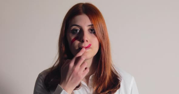 Painting Her Face with Red Line alt