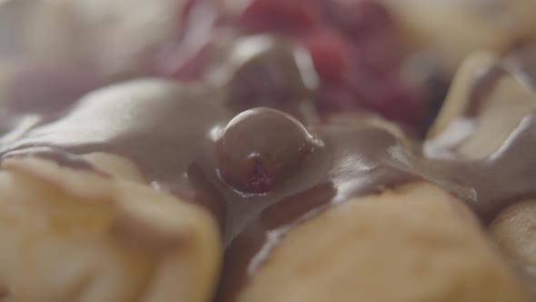 Camera Moving Along Baked Pancakes with Chocolate Syrup and Raspberries on the Top. Close-up of alt