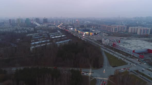 Autumn Forest and Road Junction Near Large City in Evening alt