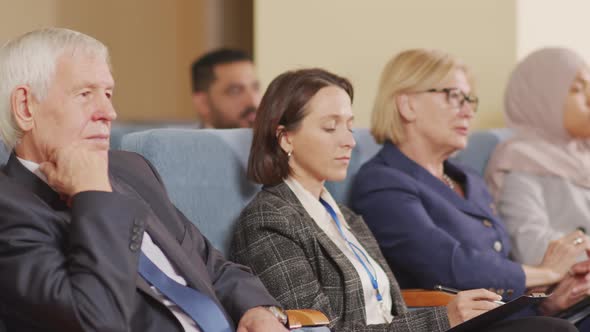 Business People Listening to Speaker at Conference alt