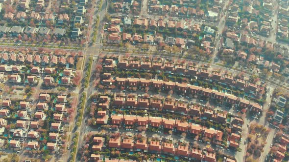 Slowly ascending over house roofs on local neighborhood in Santiago, Chile-4K alt