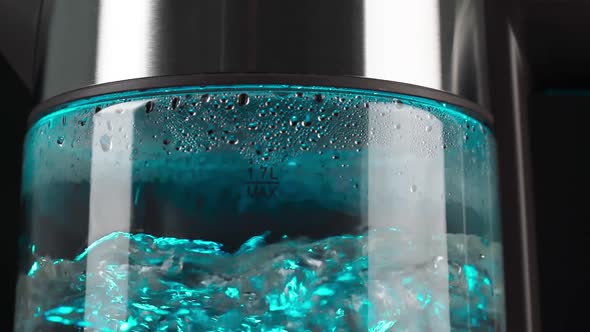 Boiling Water in a Glass Electric Kettle Rises in Bubbles in Slow Motion alt
