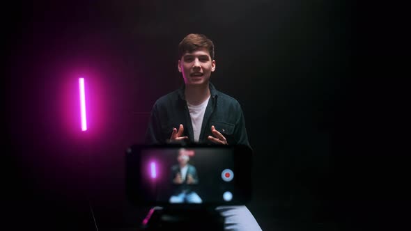 A Young Guy Shoots a Blog in a Black Studio alt