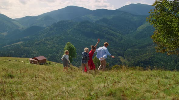 Family Enjoying Outdoor Games on Green Hill alt