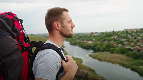 Happy Young Man in the Mountains He Rejoices Standing Against the Backdrop of a Beautiful Landscape