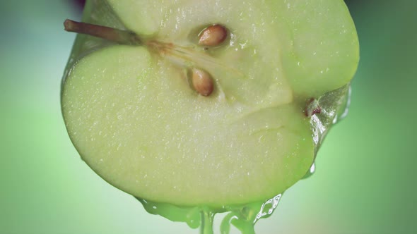 Flowing Green Apple Juice From Half Apple  Macro Shot in Slow Motion alt