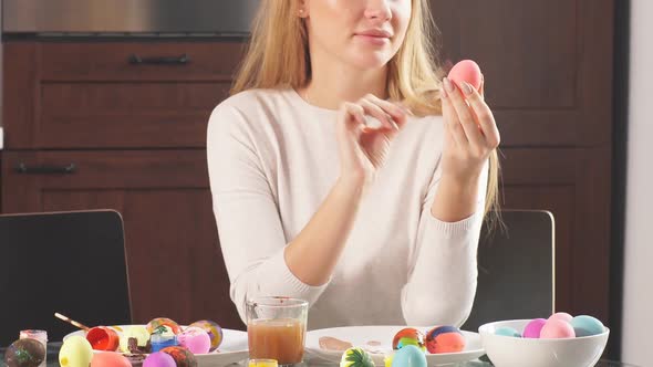 Mother Decorating Easter Eggs for Holiday alt