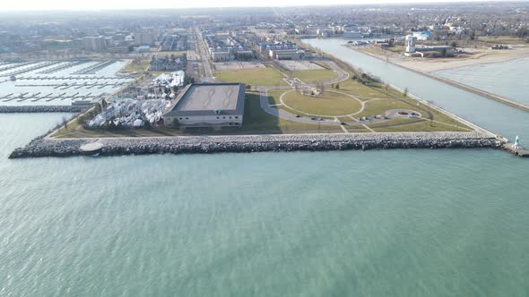 View off Lake Michigan toward shoreline with empty marina and boats in dry dock.