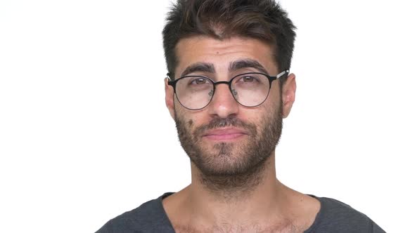 Hispanic Bearded Guy in Glasses with Brilliant Smile Looking on Camera Feeling Pleased Over White alt