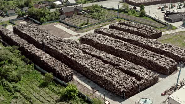Aerial View Flying Over Warehouse of Trees at a Logging Production alt