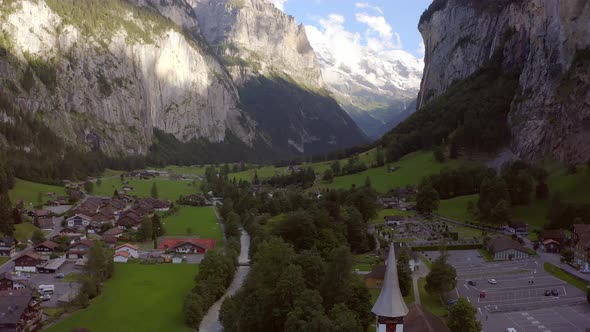 Fly up a drone in the valley of lauterbrunnen passing a little church. At the end there is a reveal alt