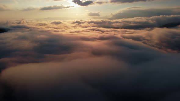 Aerial shot: Flying above Amazing Fluffy Clouds at Morning Time.