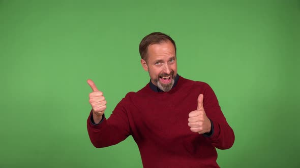 A Middleaged Caucasian Man Shows a Double Thumb Up to the Camera with a Smile  Green Screen