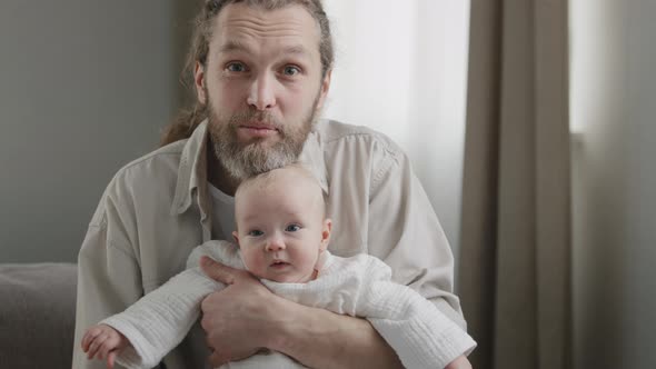 Happy Father Caucasian Middle Aged Bearded Man with Little Daughter Baby Son Newborn Infant Looking alt
