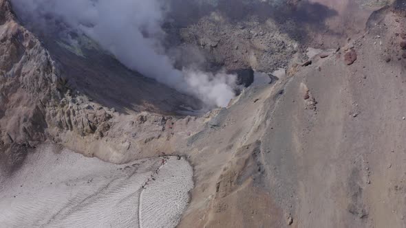 People Hiking on Mutnovsky Volcano Crater with Fumaroles and Glacier