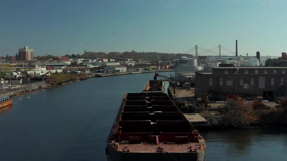 Fly Over Cargo Ship Moored at Bank alt