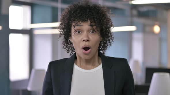 Portrait of Shocked African Businesswoman Reacting To Failure By Hand Gesture alt