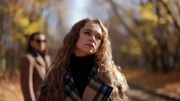 Woman is Leaving Her Exboyfriend in Park in Autumn Day Walking Away Breakup of Loving Couple alt