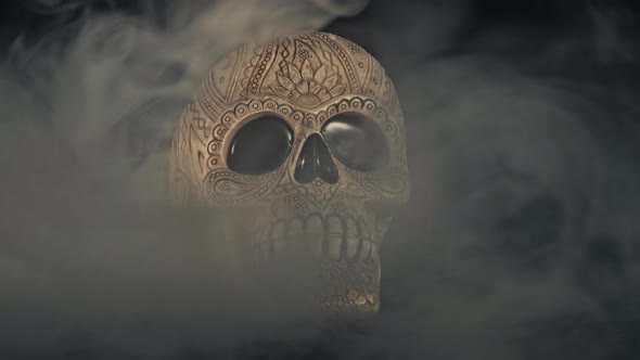 Skull Covered In Smoke On A Dark Background.