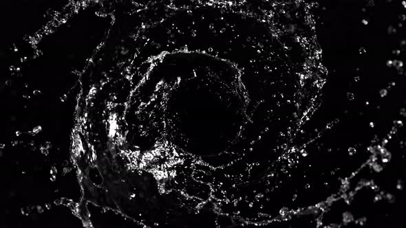 Super Slow Motion Shot of Rotating Water Splash Isolated on Black Background at 1000Fps. alt