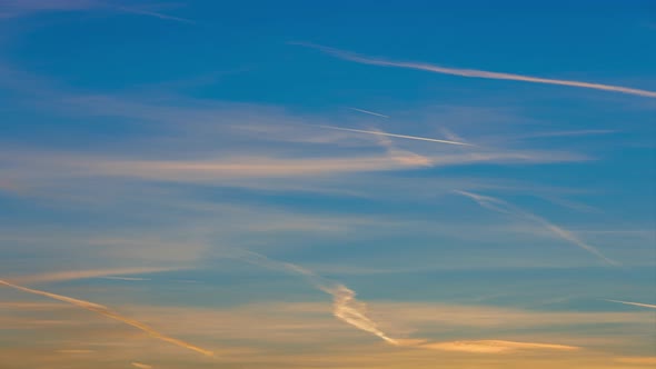 Orange Feather Clouds and Plane Trails at Sunrise  Timelapse