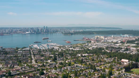 Wide aerial view of Vancouver Harbour and the downtown skyline from Central Lonsdale. alt