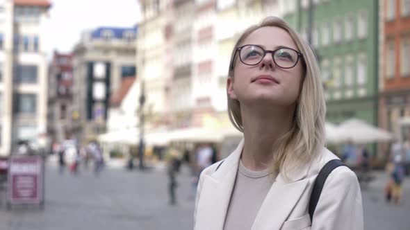 Stylish woman in eyeglasses in city of Europe