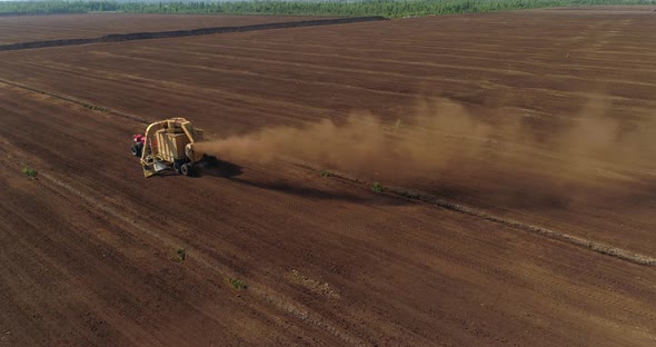 Peat Harvesting Machinery Extracting Peat Turf in Drained Bog Aerial View alt
