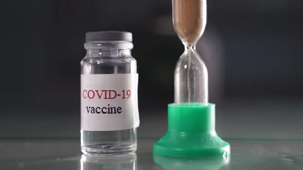 Covid 19 Vaccine Bottle Closeup Covid 19 Bottle and Vaccine Hourglass Closeup