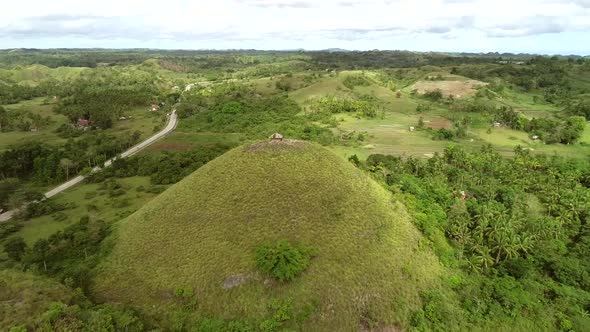 Aerial view of house on the top of Chocolate Hills Complex, Batuan, Philippines. alt