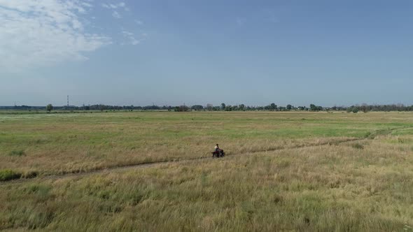 Video Footage of a Man Riding a Motorcycle Through the Fields