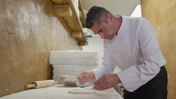Caucasian man making a pizza dough alt