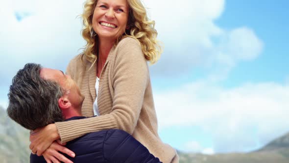 Mature couple enjoying on beach alt