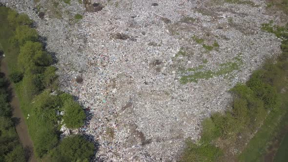 Crowded Landfill. Shooting From a Quadcopter of a Landfill. Garbage Is Dumped at the Entrance.