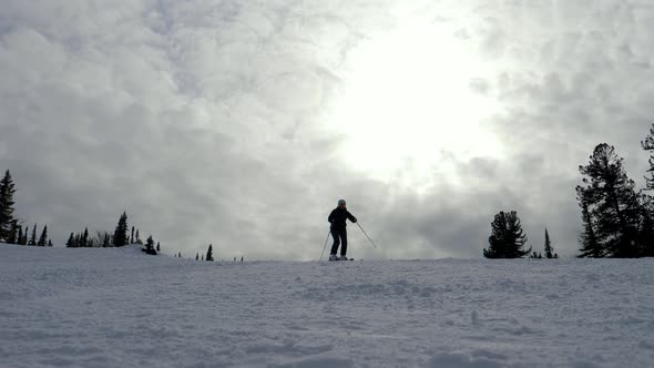 Mountain Skier Skiing On Ski Slope In Mountain Resort On Sunny Day At Winter alt
