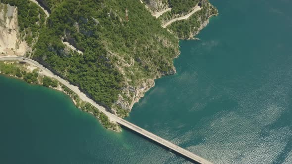 Aerial Footage a Car Driving Over a Bridge on Piva Lake