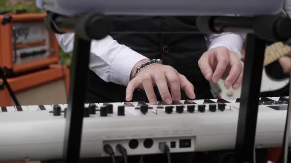 A Musician Plays Music on an Electronic Piano