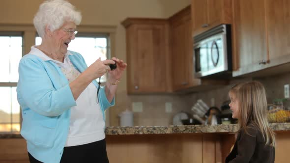 Great grandmother in kitchen with young girl alt
