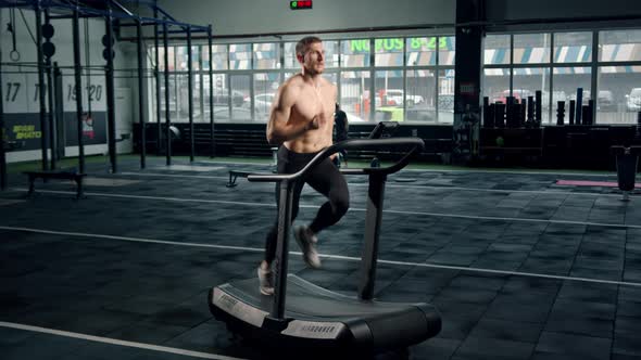 Male athlete athlete is doing cardio training on a treadmill, bodybuilder is running alt