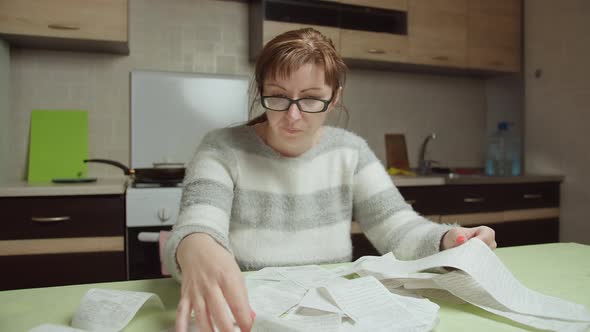 Woman Examines the Purchases Made and the Prices at Home