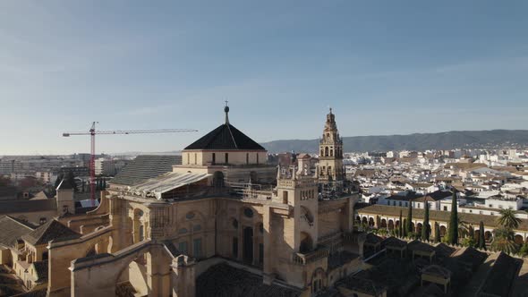 Aerial pan revealing the top parts of Mosque-Cathedral of Cordoba, Spain