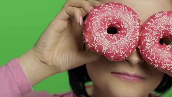 Happy Beautiful Young Girl Posing and Having Fun with Donuts. Chroma Key alt