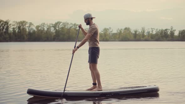 Man Sup Surfing .Stand up Paddling Surfboard. Inflatable Board For Rowing. Surfer Balance Watersport alt